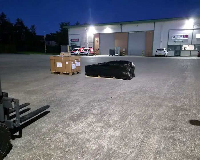 Pallets ready for collection outside the X-Press Couriers depot at night
