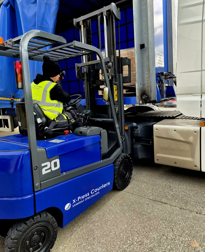 An articulated delivery being unloaded by forklift at the X-Press Couriers warehouse