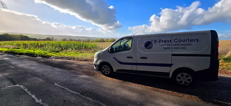 X-Press Couriers van on a country road during a long-distance same-day delivery